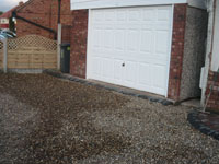 Royale garage with gravelled  driveway & bow top fencing 